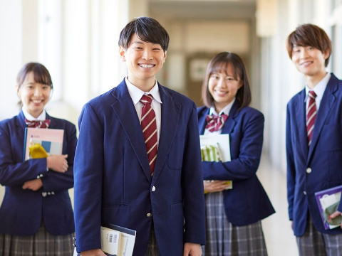 Smiling Japanese high school students successfully preparing for EIKEN and IELTS exams.
