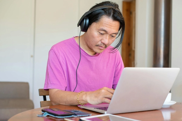 Dedicated student attending a live online English lesson from a laptop.