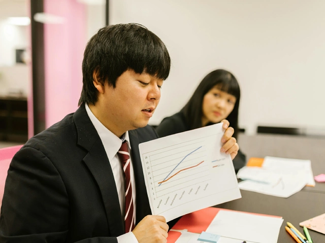 Japanese male english  student facilitating a safe and inclusive group discussion.